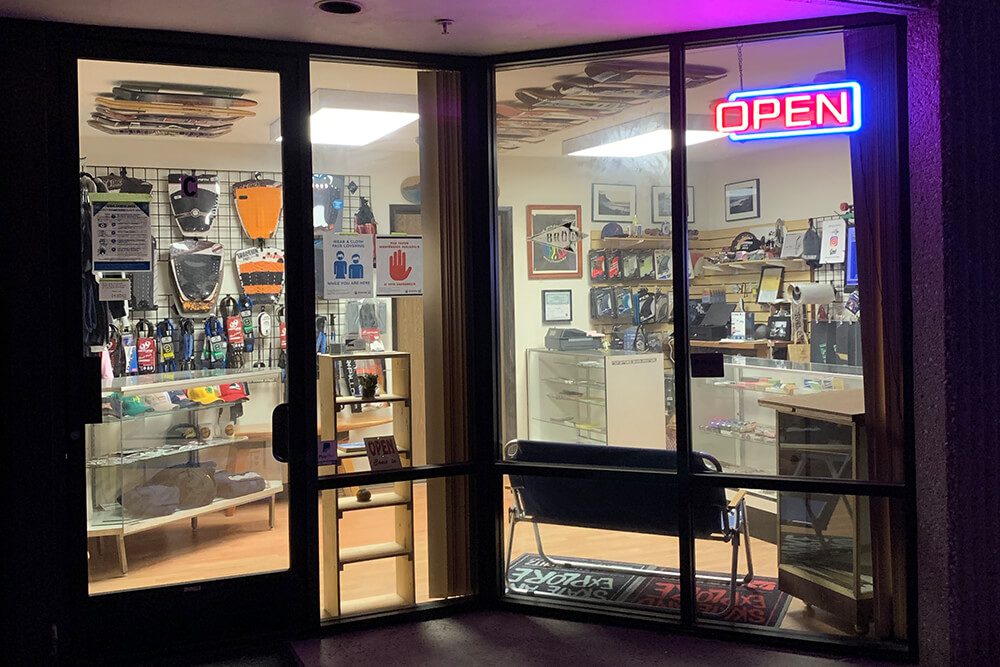 Entrance to a well-lit hobby or craft store with various supplies and an open sign.